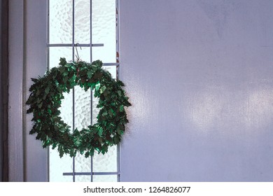 Beautiful Mistletoe Hanging On White Door