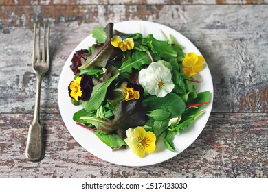 Beautiful mix of salads with flowers on a white plate. Diet concept. Nutrition for girls. Healthy vegan food. - Shutterstock ID 1517423030