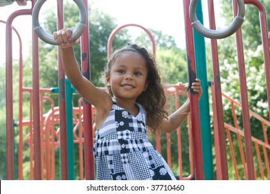 A Beautiful Mixed Race Child Enjoying The Playground