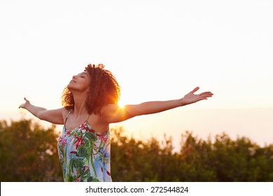 Beautiful mixed race woman expressing freedom outdoors with her arms outstretched - Shutterstock ID 272544824