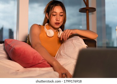 Beautiful Mixed Race Woman Watching Series On Laptop At Night.