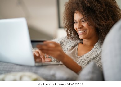 Beautiful mixed-race woman shopping on internet - Shutterstock ID 512471146
