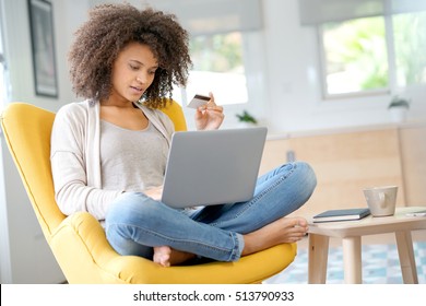 Beautiful mixed-race woman shopping on internet - Shutterstock ID 513790933