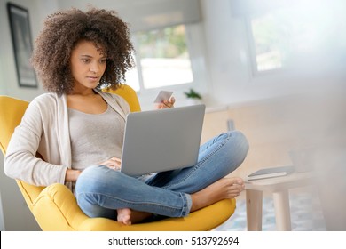Beautiful mixed-race woman shopping on internet - Shutterstock ID 513792694