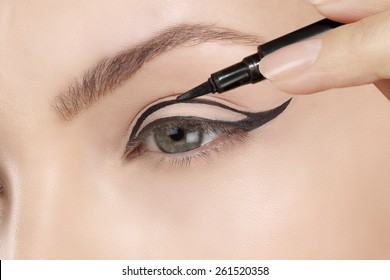 Beautiful Model Applying Eyeliner Closeup On Eye