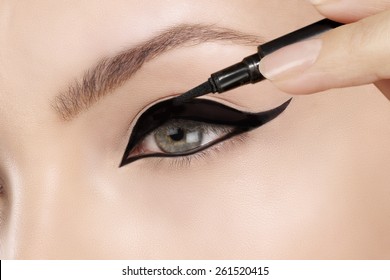 Beautiful Model Applying Eyeliner Closeup On Eye