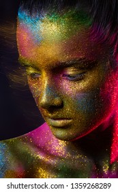 Beautiful model with creative make-up. gold, yellow, blue, purple and green paint on the skin, space and stars. Metal powder, glitter. Face close-up. Long exposure - Shutterstock ID 1359268289