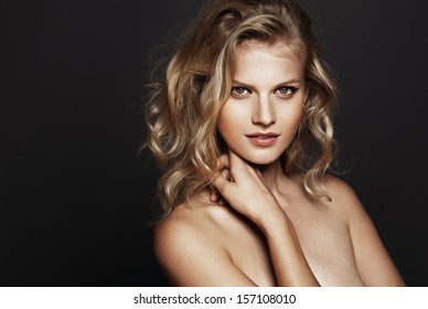 Beautiful Model With Curly Blond Hair On Black Background 