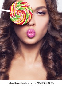 Beautiful Model With Curly  Hair, Smile And Brigth Light With Candy Lolipop