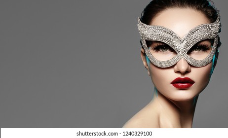 Beautiful Model With Fashion Lips Makeup Wearing Bright Brilliant Mask. Masquerade Style Woman. Holiday Celebration Look. Horizontal Beauty Photo