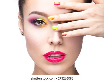 Beautiful model girl with bright colored makeup and nail polish in the summer image. Beauty face. Short colored nails. Picture taken in the studio on a white background.