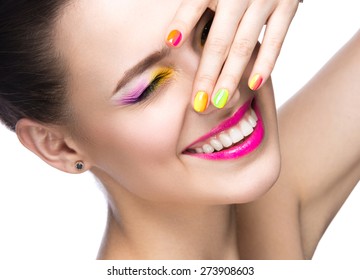 Beautiful model girl with bright colored makeup and nail polish in the summer image. Beauty face. Short colored nails. Picture taken in the studio on a white background.