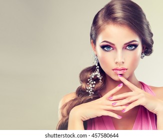 Beautiful Model Girl With Elegant Hairstyle . Woman With Fashion Wedding Hair  . Cosmetics, Beauty And Manicure On Nails