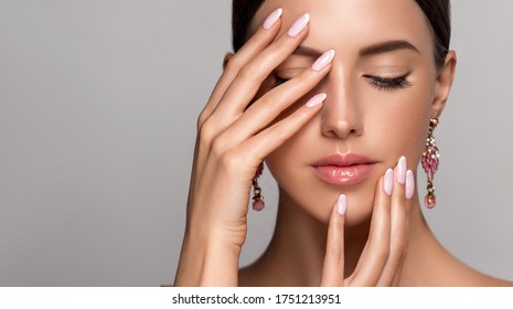 Beautiful model girl with  french manicure nail , Jewelry, earrings and accessories. Fashion makeup and care for hands , nails and cosmetics .