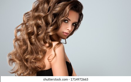 Beautiful model girl with long wavy and shiny hair . Brunette woman with curly hairstyle
 - Shutterstock ID 1714972663