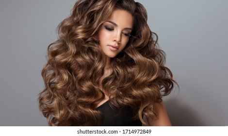Beautiful model girl with long wavy and shiny hair . Brunette woman with curly hairstyle
 - Shutterstock ID 1714972849