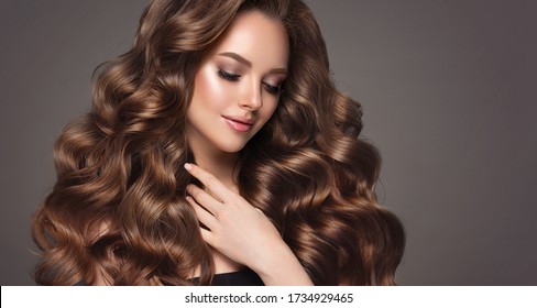 Beautiful model girl with long wavy and shiny hair . Brunette woman with curly hairstyle - Shutterstock ID 1734929465