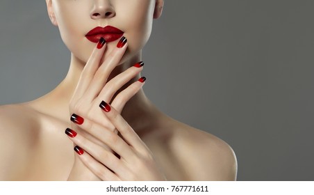 Beautiful model girl with red and black  french manicure on nails . Fashion luxury makeup . Beauty  and cosmetics .