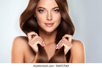 Beautiful Model Girl With Shiny Brown Straight Long  Hair . Care And Hair Products .