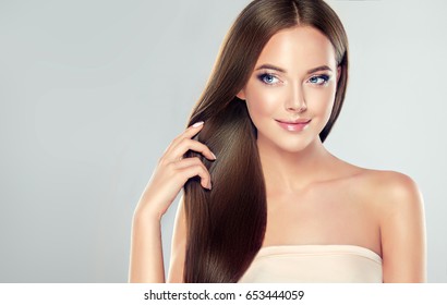 Beautiful Model Girl With Shiny Brown Straight Long  Hair . Care And Hair Products .