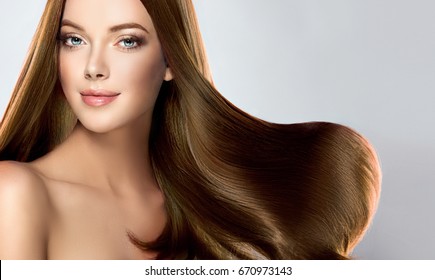 Beautiful model girl with shiny brown straight long  hair . Care and hair products . - Shutterstock ID 670973143