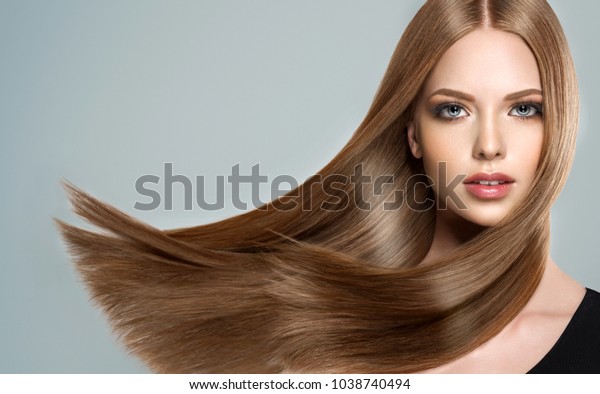 Beautiful model girl with shiny brown and\
straight long  hair . Keratin  straightening . Treatment, care and\
spa procedures. Smooth\
hairstyle