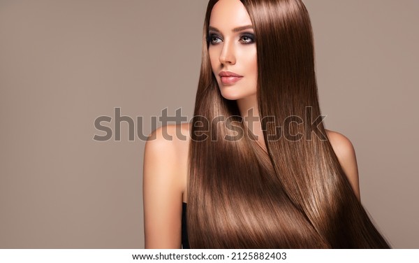 Beautiful model girl with shiny brown and\
straight long  hair . Keratin  straightening . Treatment, care and\
spa procedures. Smooth\
hairstyle\
