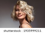 Beautiful model girl with short hair .Beauty  smiling woman with blonde curly hairstyle dye .Fashion, cosmetics and makeup
