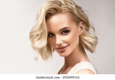 Beautiful model girl with short hair .Beauty woman with blonde curly hairstyle dye .Fashion, cosmetics and makeup - Shutterstock ID 1935999115