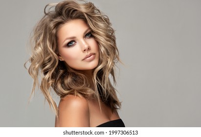 Beautiful Model Girl With Short Hair .Beauty Smiling Woman With Blonde Curly Hairstyle Dye .Fashion, Cosmetics And Makeup
