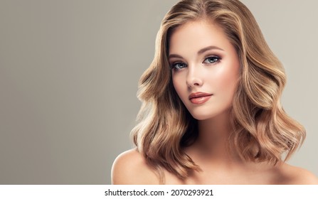 Beautiful model girl with short hair .Beauty woman with blonde curly hairstyle dye .Fashion, cosmetics and makeup - Shutterstock ID 2070293921