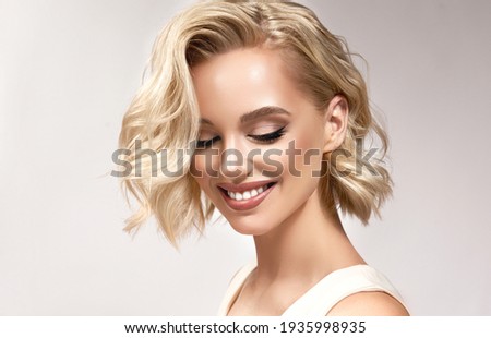 Similar – Image, Stock Photo Short-haired blonde smiles as she talks on the phone in the fall outdoors