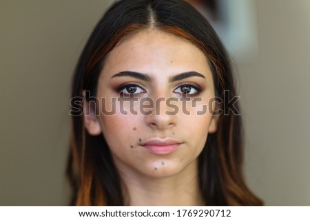 Beautiful model in make up process. Portrait of young pretty woman with beutiful makeup in beauty studio salon. Evening make up, blurry background