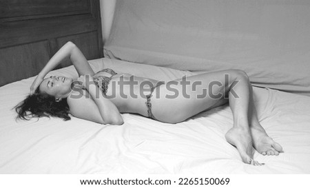 beautiful model posing in bed in bikini