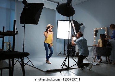 Beautiful model posing for professional photographer in studio - Powered by Shutterstock