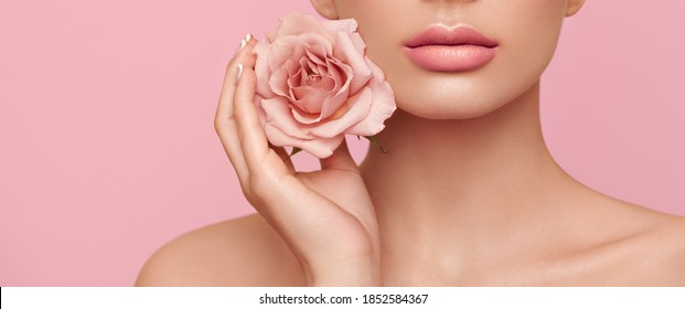 Beautiful Model With A Rose. Perfect Woman Face Makeup Close Up. Lipstick. Beautiful Nails. Nice Smile. Perfect Skin