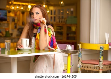 Beautiful Model Smoking Hookah In A Cafe