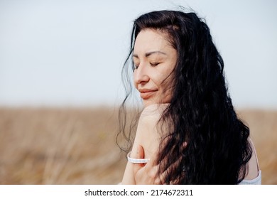 Beautiful Model Wearing Summer Cotton Dress Posing In Autumn Field With Hay Stack. Boho Style Clothing.