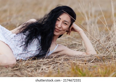 Beautiful Model Wearing Summer Cotton Dress Posing In Autumn Field With Hay Stack. Boho Style Clothing.