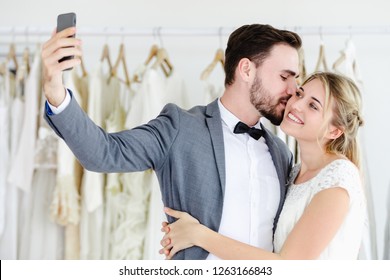 Beautiful Model Wedding Couple Holding Smartphon Online Video Call Looking At Screen,social Networking