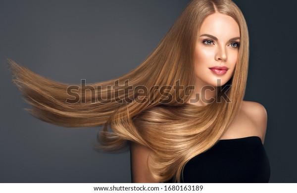 Beautiful model woman with shiny \
and straight long hair. Keratin  straightening. Treatment, care and\
spa procedures. Blonde beauty  girl smooth\
hairstyle