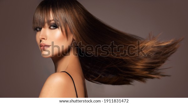 Beautiful model woman with shiny  and\
straight long hair. Keratin  straightening. Treatment, care and spa\
procedures. Beauty  girl smooth\
hairstyle