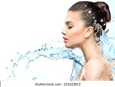 Beautiful Model Woman with splashes of water in her hands. Beautiful Smiling girl under splash of water with fresh skin on white background. Skin care, Cleansing and moisturizing concept. Beauty face 