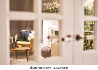 Beautiful Modern Door Knob. Christmas Lights On The Background. Open, Wooden Front Door From The Interior Of An Upscale Home With Windows.