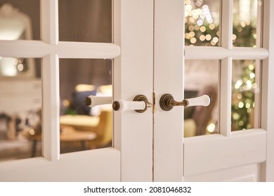 Beautiful Modern Door Knob. Christmas Lights On The Background. Open, Wooden Front Door From The Interior Of An Upscale Home With Windows.