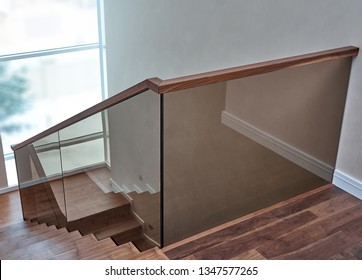 Beautiful modern glass railing for wooden staircase with wooden handrail - Powered by Shutterstock