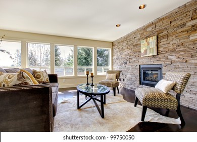 Beautiful Modern Large Bright Living Room With Dark Floor And Stone Wall.