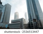 Beautiful modern metropolis in the fog with business and office buildings and the Palace of Culture in Warsaw. Amazing foggy city of Warsaw with sun, Poland on a cloudy, overcast day. Urban wallpaper 