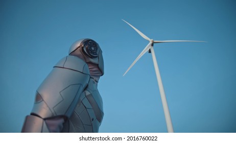 Beautiful Modern Robot Engineer On Windmill Farm Checking The Process Looking Around. Modern Technology Innovation. Workflow Automation Concept. Human Future. High Quality Photo