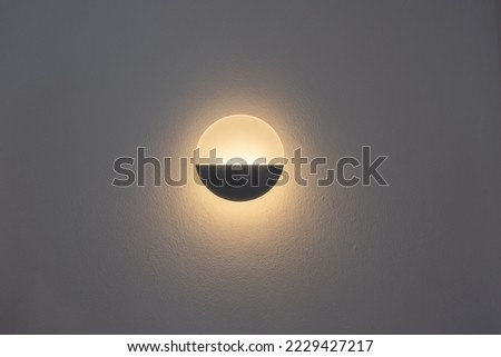 Beautiful modern round shape wall lamp light bulb decoration for home and living on the white cement wall background with copy space for text. Concept building interior contemporary.
